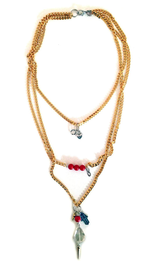 Layered necklace in gold, coral and hamsa.
